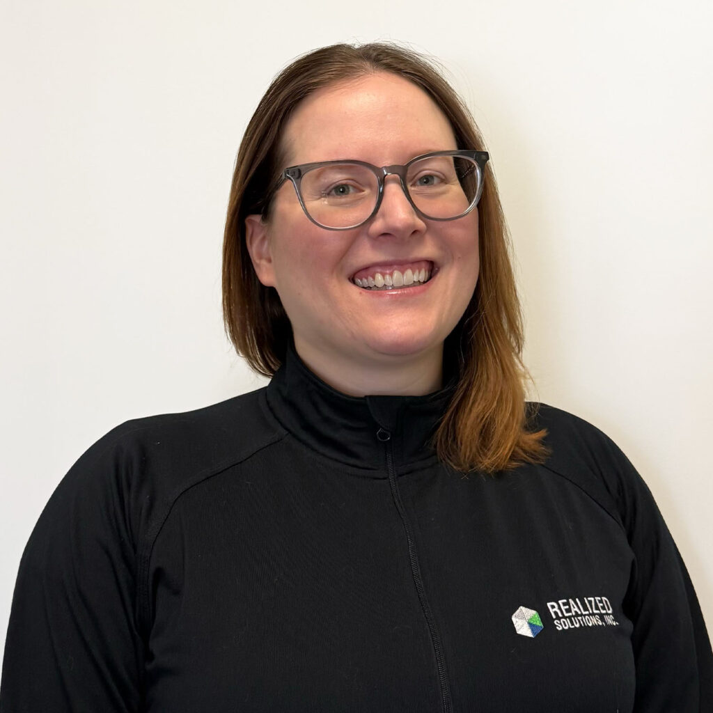 Kaylee Byram, Software Division Manager at RSI, smiling in a professional headshot for Realized Solutions Inc. website.