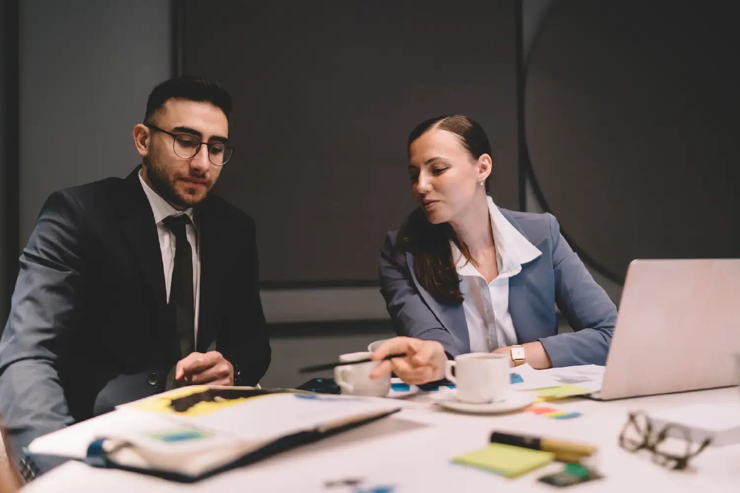 A professional team in a modern office discussing a strategic IT partnership and custom software development to drive business growth.