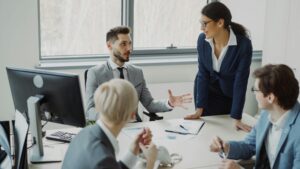 Business professionals participating in a team meeting, discussing reports and collaborating on strategy in a modern office.
