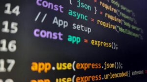 Programming code displayed on a computer monitor, representing software development, application programming, web development, and technology solutions.