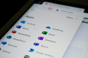 Microsoft 365 app dashboard on a mobile device showing Outlook, Word, Excel, Teams, OneDrive, and other productivity applications for business collaboration and cloud-based work.